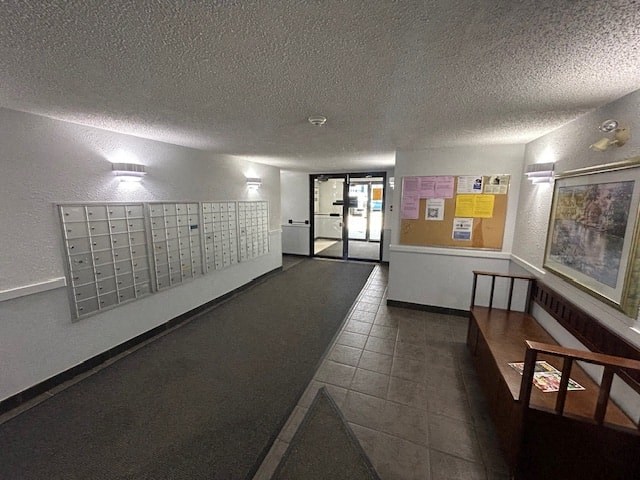 a hallway with a seating area and a door