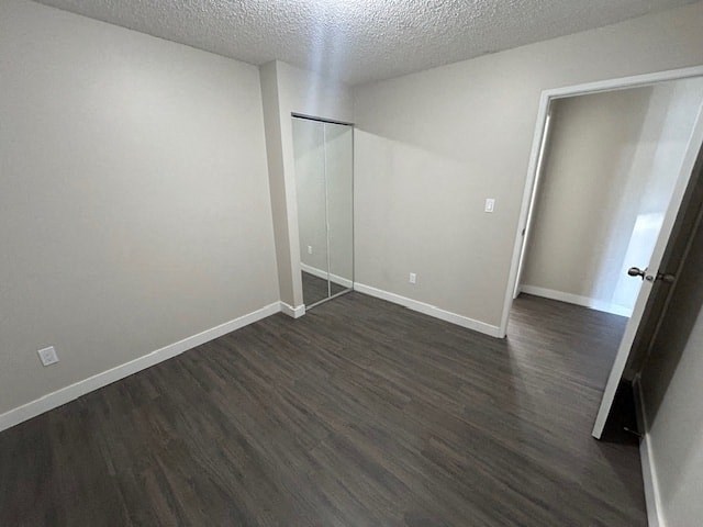 an empty living room with wood floors and a sliding glass door