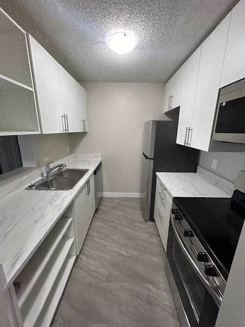 an empty kitchen with white cabinets and a sink