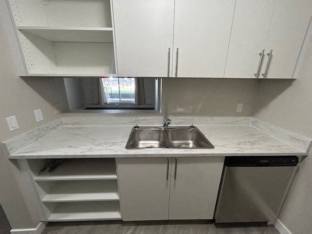 a small kitchen with a sink and white cabinets