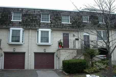 a white brick house with two garage doors