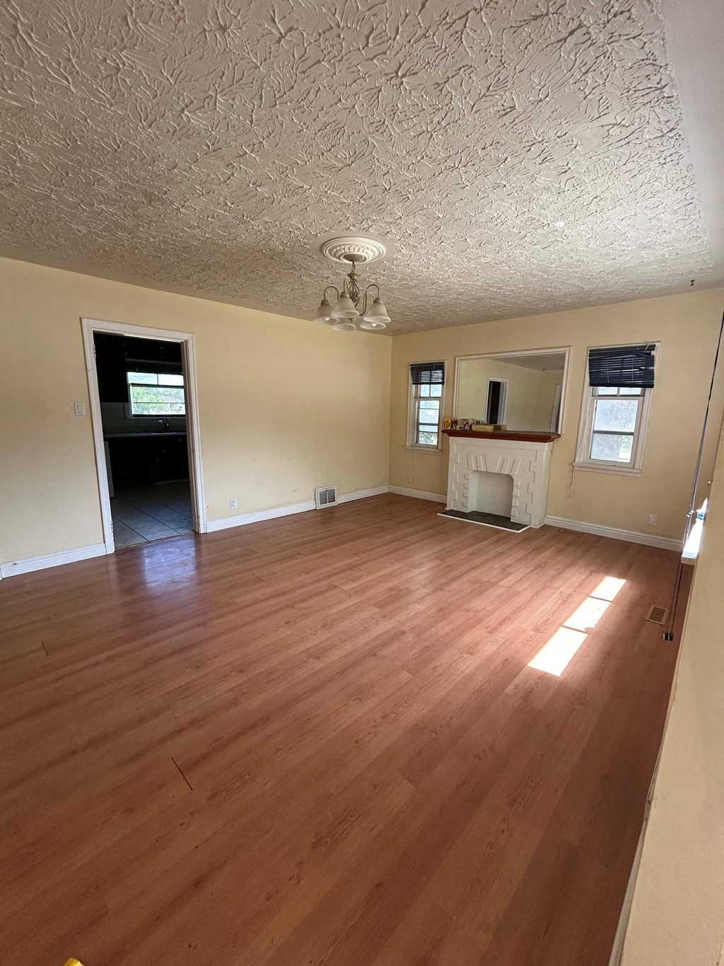 an empty living room with a hard wood floor