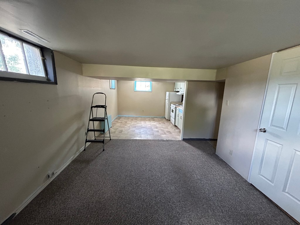 an empty room with a ladder in the middle of it