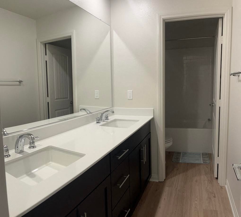 a bathroom with two sinks and a large mirror