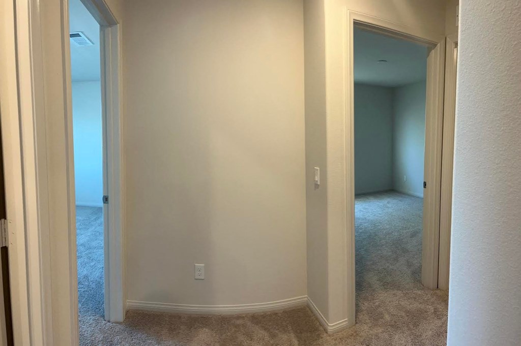 a room with a hallway and a door to a bedroom