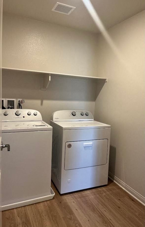 two washers and dryers in a room