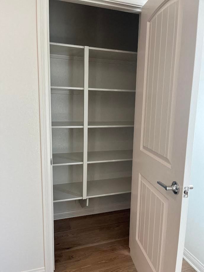 a closet with empty shelves and a white door