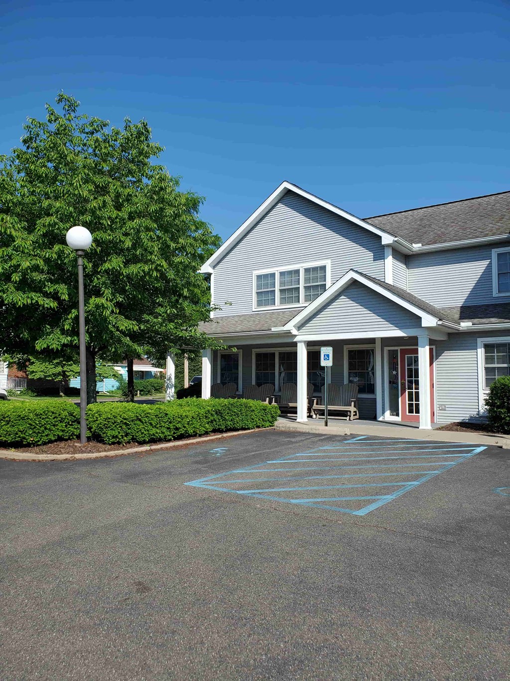 a parking lot in front of a house with a driveway