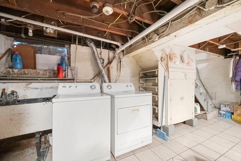 a laundry room with two washes and two dryers in it