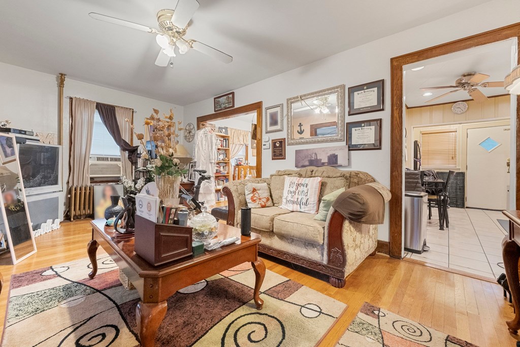 a living room with a couch and a table     and a kitchen
