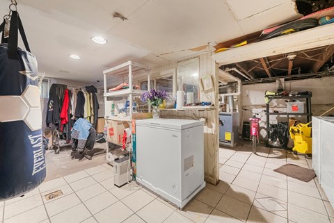 a small room with a refrigerator and cabinets in it