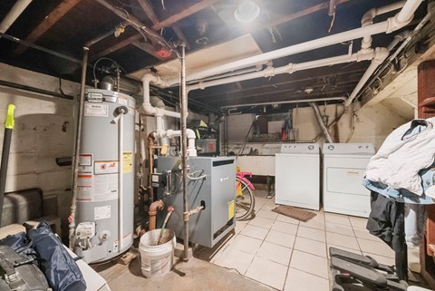 the basement of a home with a lot of heating and cooling equipment