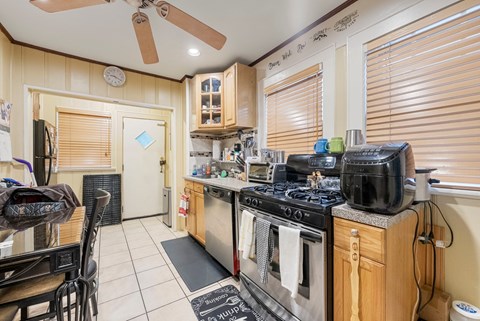 a kitchen with stainless steel appliances and wood cabinets