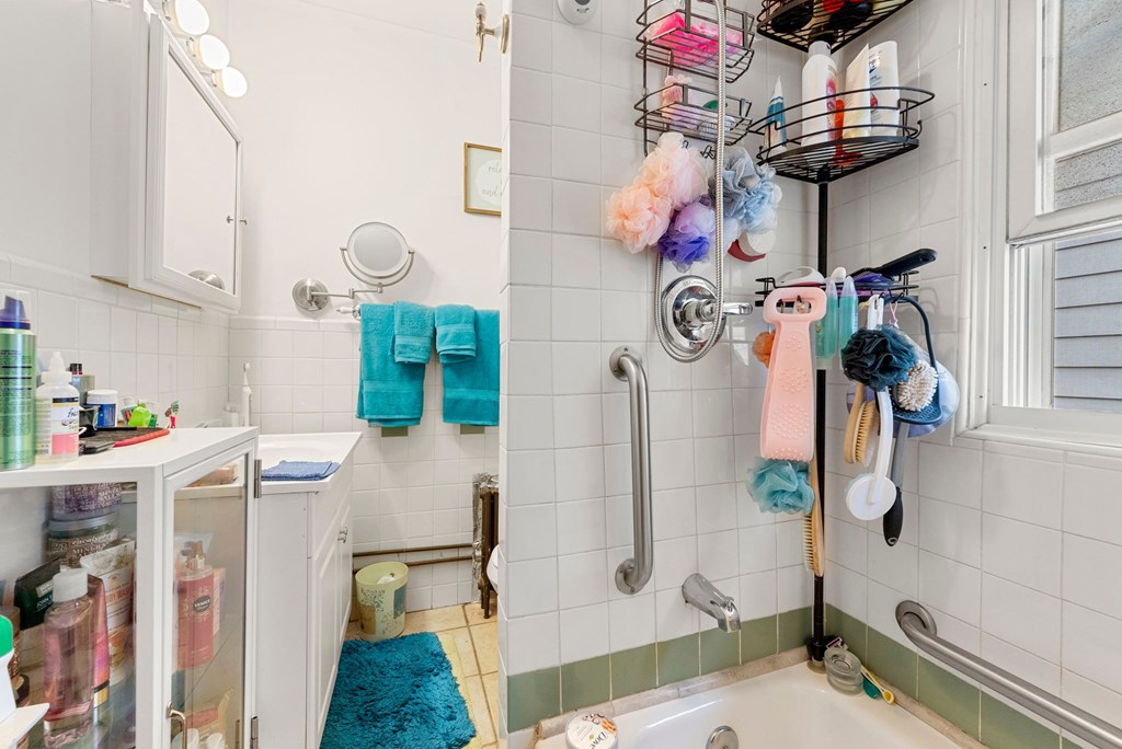 a bathroom with a shower and a sink and a mirror