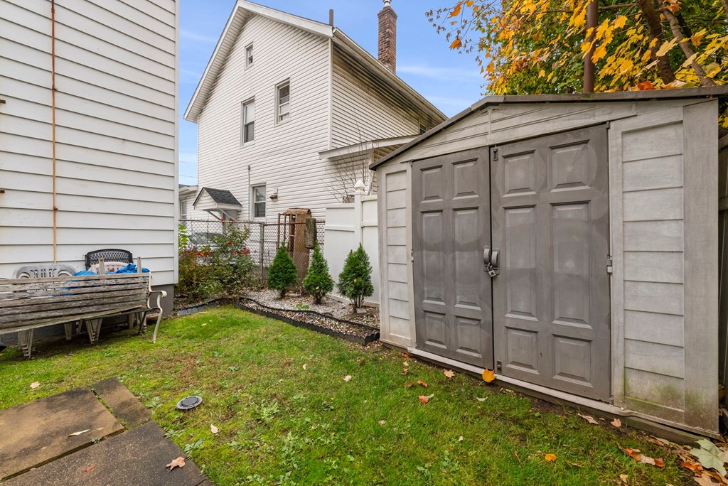 a backyard with a shed and a house