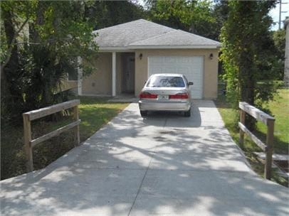 A car is parked in front of a garage.