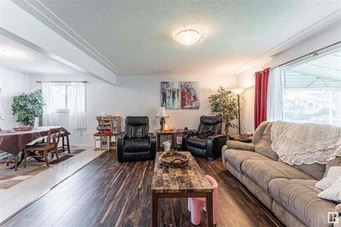 a living room with a couch and chairs and a table