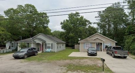 Two houses with cars parked in front.