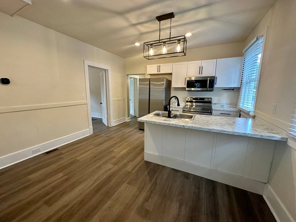 a kitchen with a marble counter top and