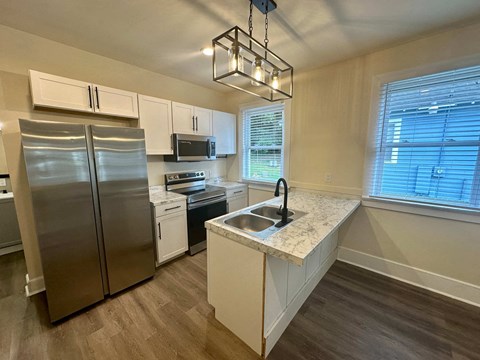 a kitchen with a sink and a refrigerator