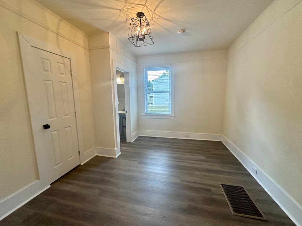 a living room with wood floors and a white door