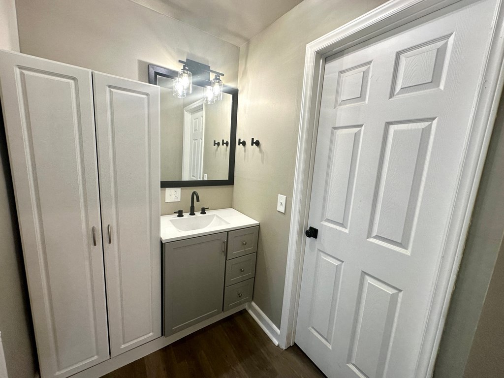 a small bathroom with a sink and a mirror