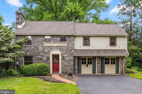 A house with a red door and a stone chimney.