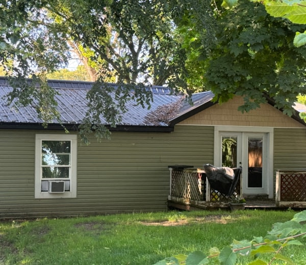 a house with a metal roof and a deck