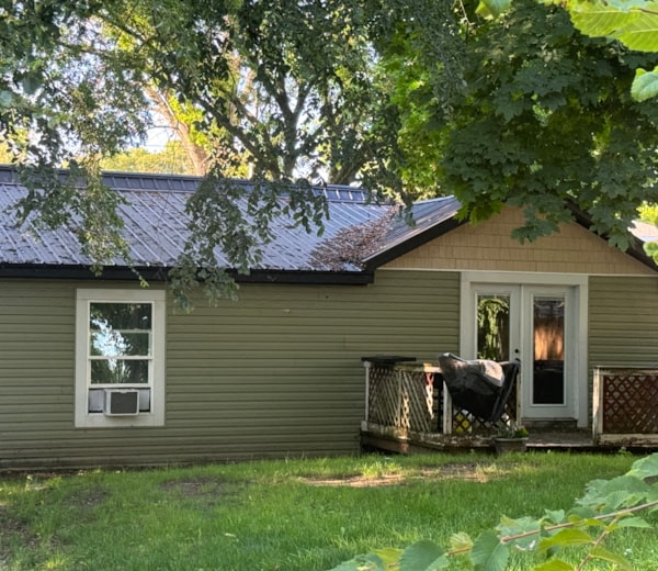 a house with a metal roof and a deck