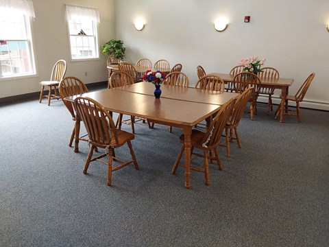 a large dining room with a wooden table and chairs
