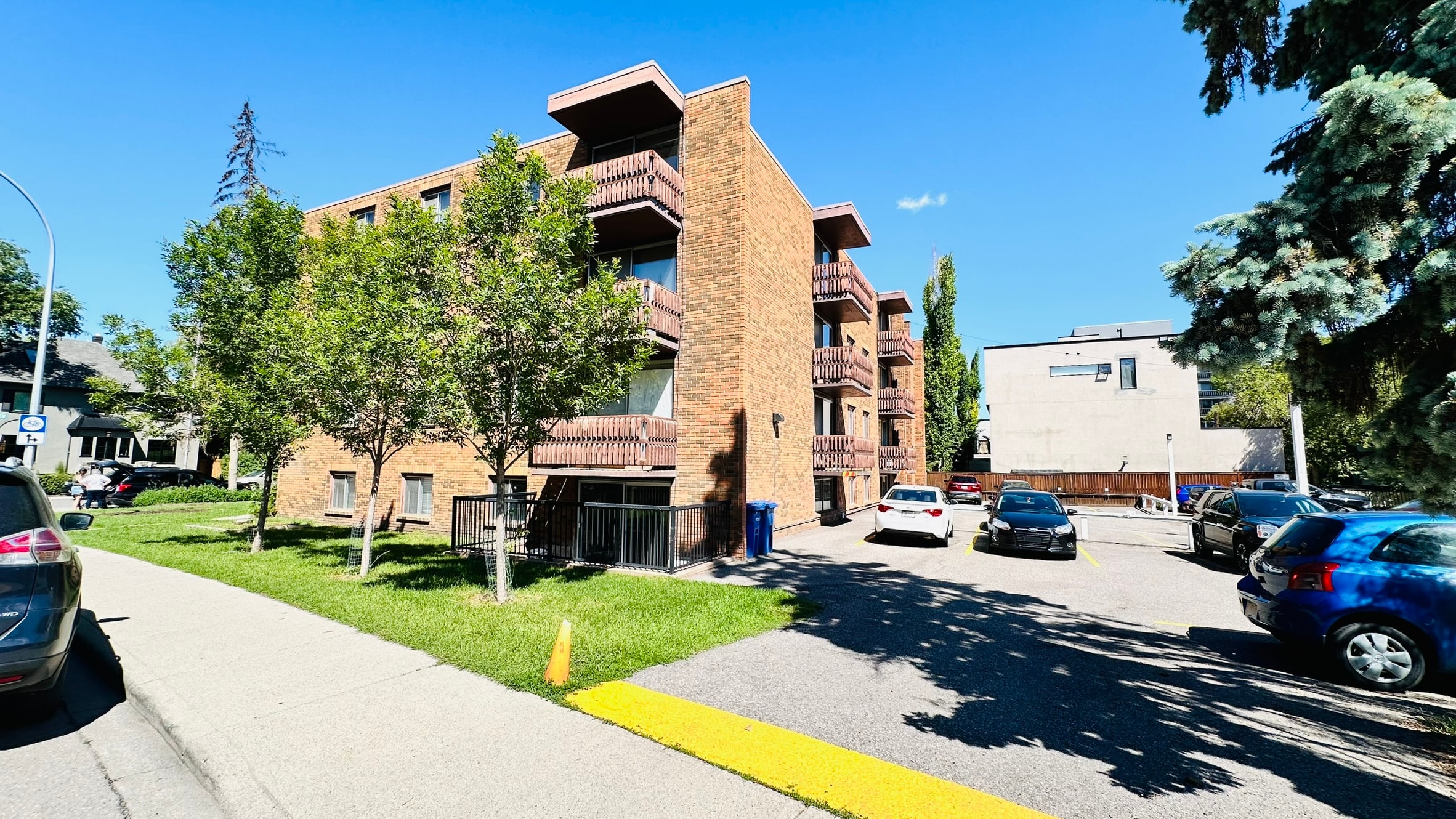 A building with a yellow line on the sidewalk in front of it.