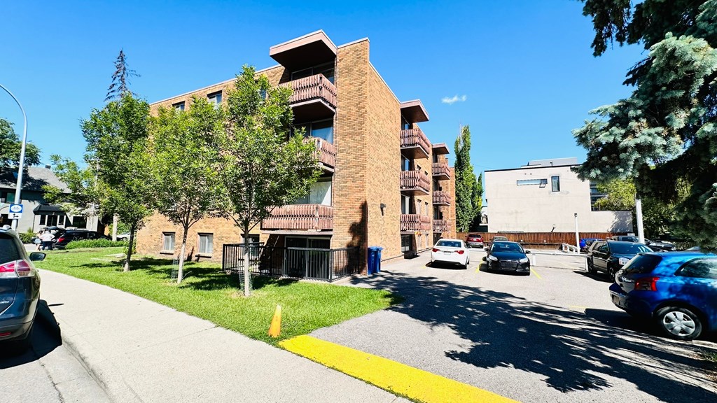 A building with a yellow line on the sidewalk in front of it.