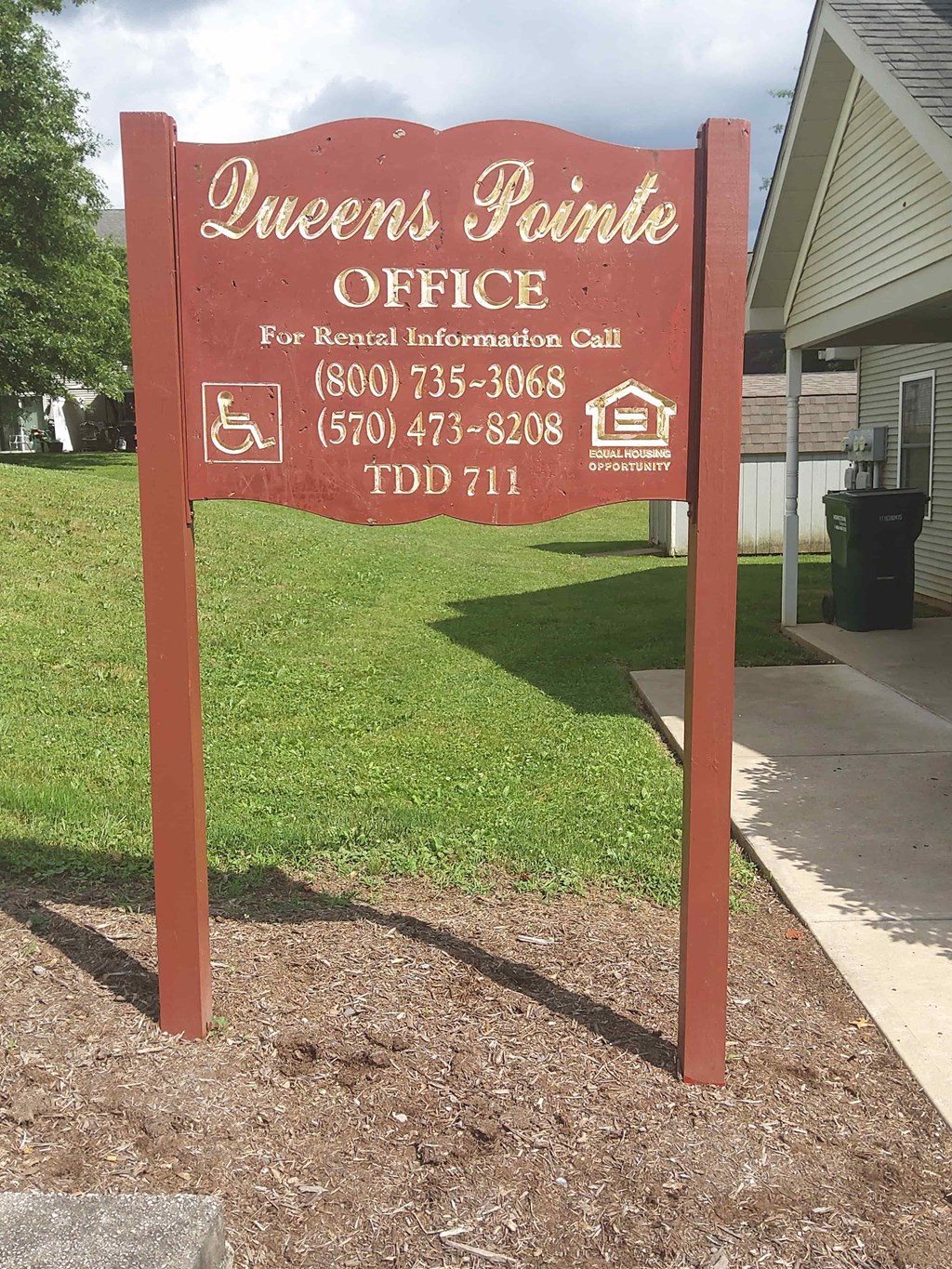 a sign for the owners panic office in front of a house