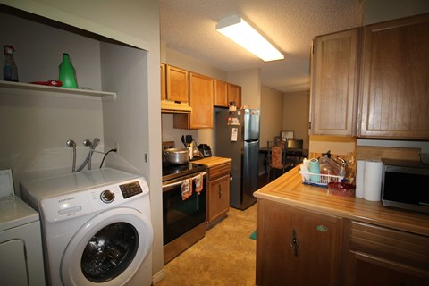 a kitchen with a washer and dryer in it