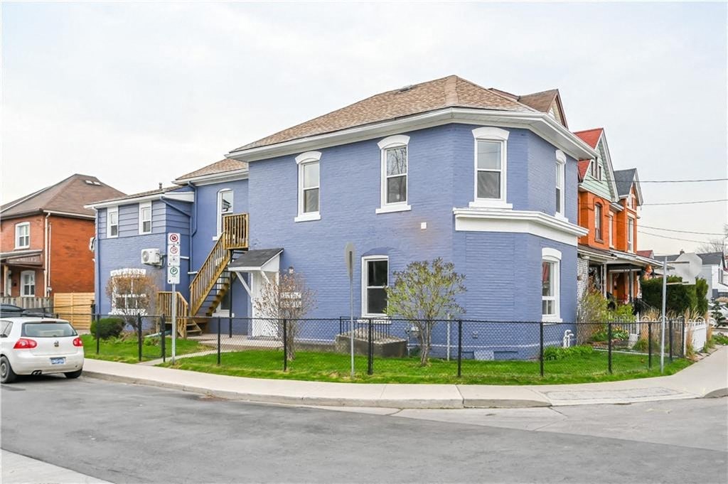 a blue house on the corner of a street