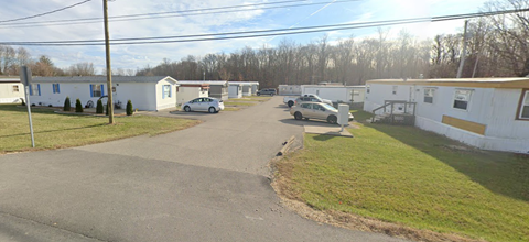 a row of mobile homes on the side of a street