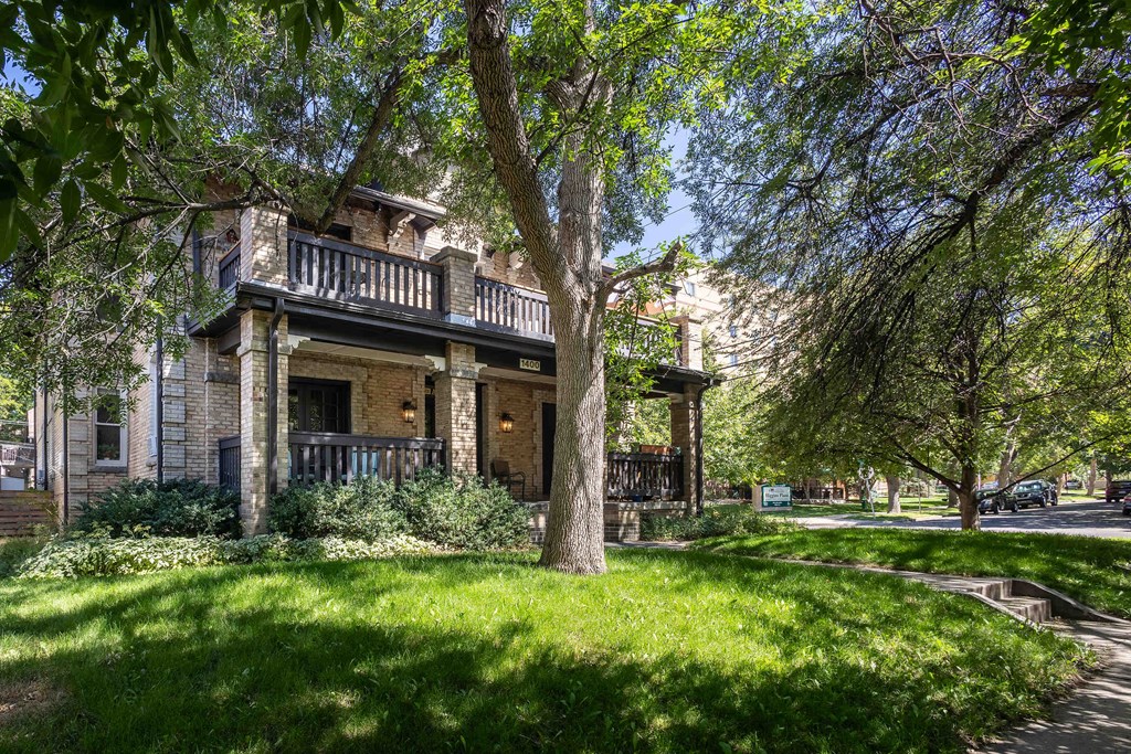 a house with trees and grass in front of it