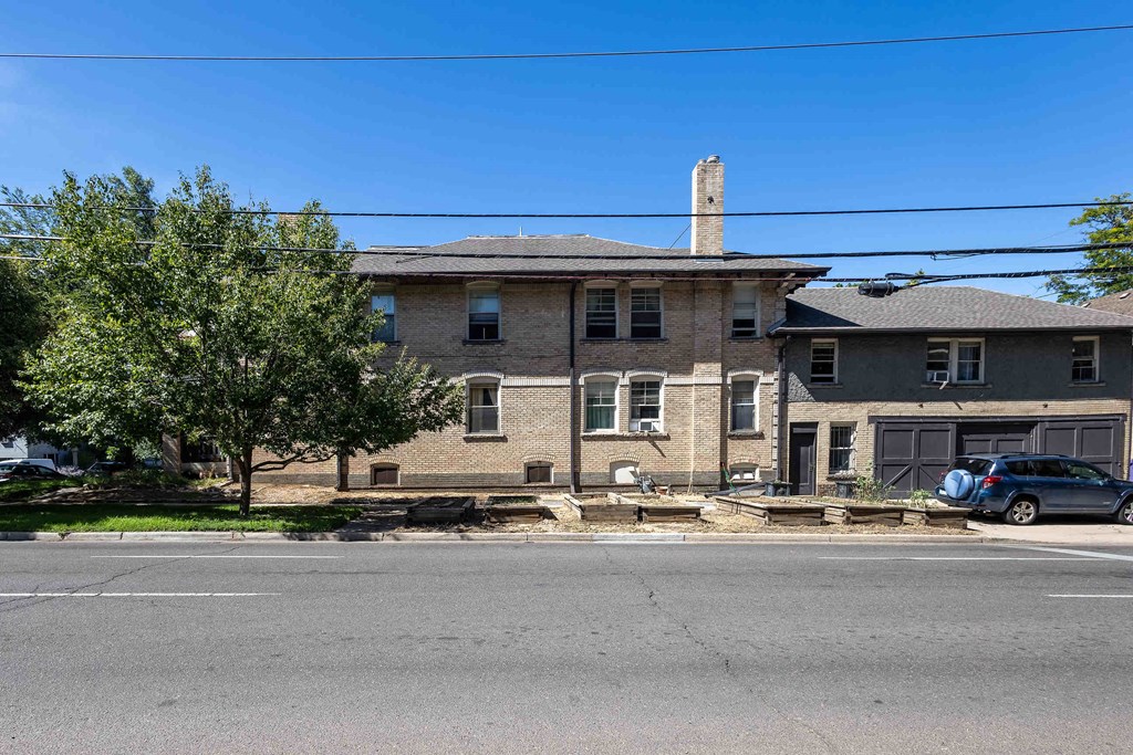 an old brick house on the corner of a street