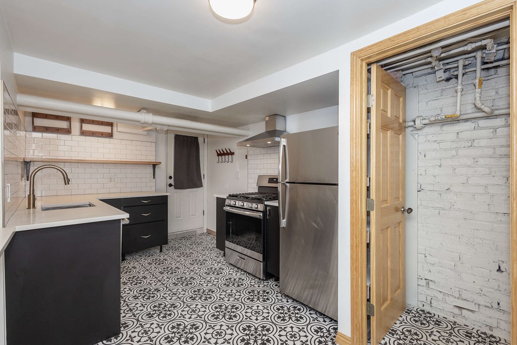a kitchen with a sink and a stove and a refrigerator