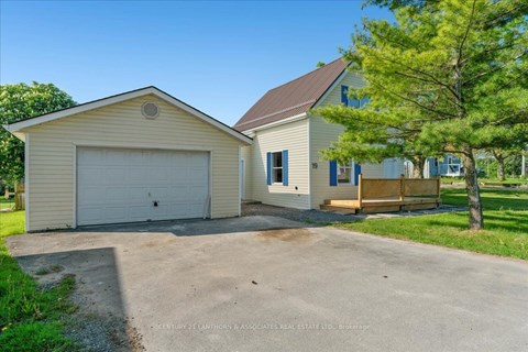 A two-story house with a garage is for sale.