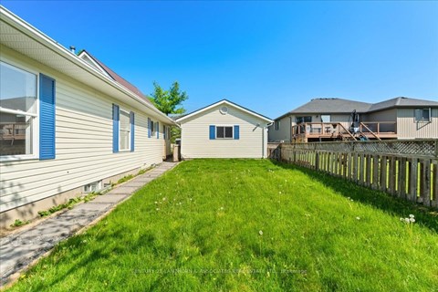 A sunny day at a residential area with houses and green lawns.