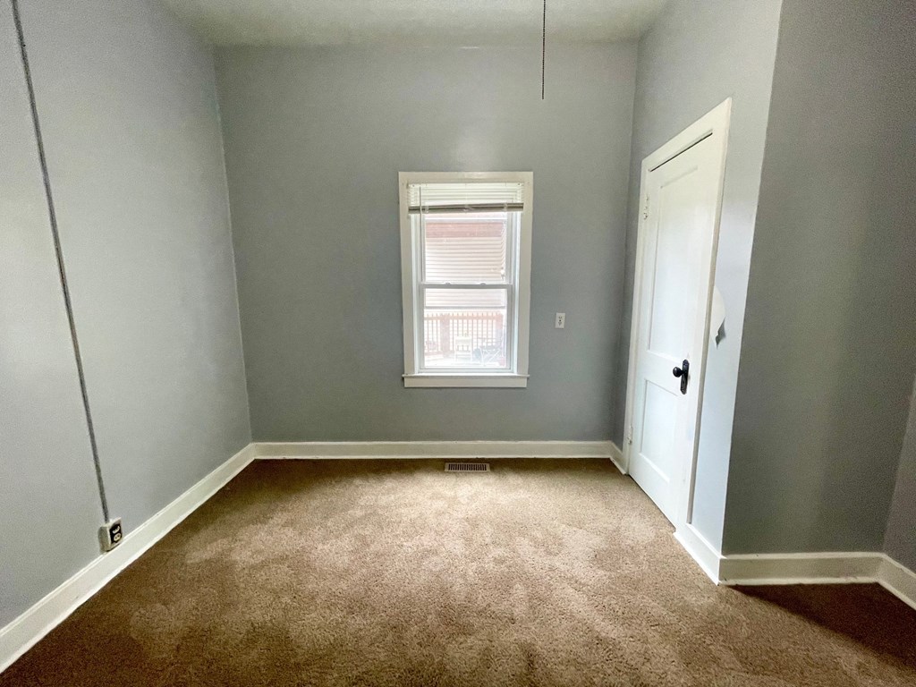a empty room with blue walls and a window