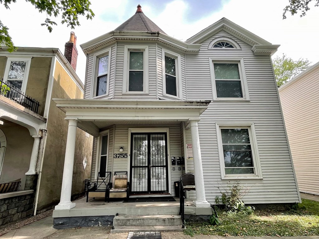 a renovated house with a front porch and a front door