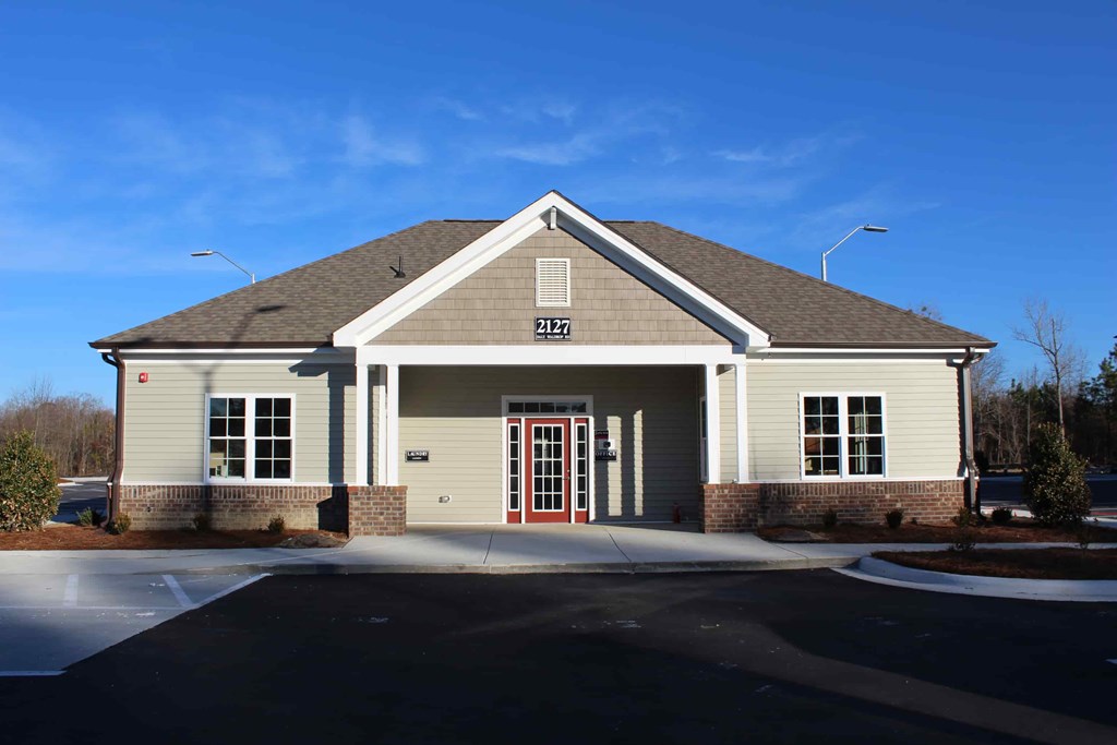 the front of a house with a red door