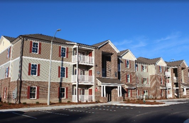 an apartment building on the corner of a street