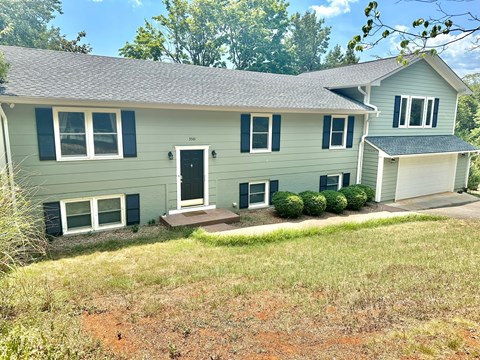 a house with a front porch and a lawn