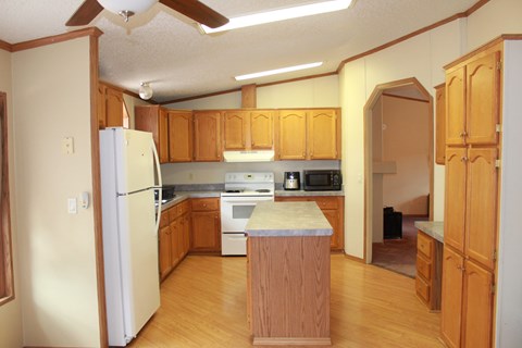a kitchen with wooden cabinets and a white refrigerator