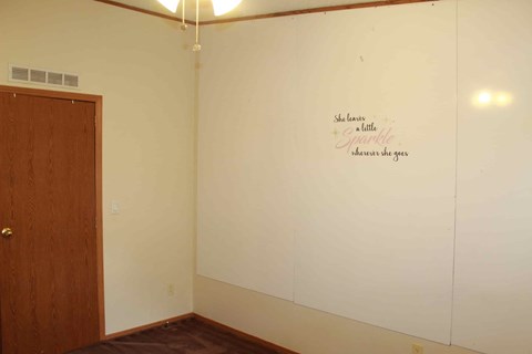 a white wall with a scripture on it in a room