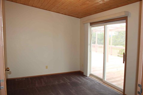 an empty living room with a sliding glass door