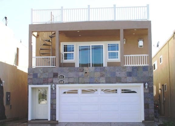 a house with a white garage door in front of it